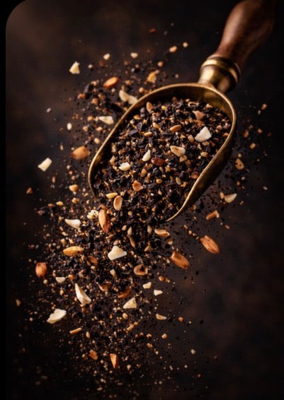 Gold scoop filled with Chantilly Earl Grey Tea Blend on a dark surface