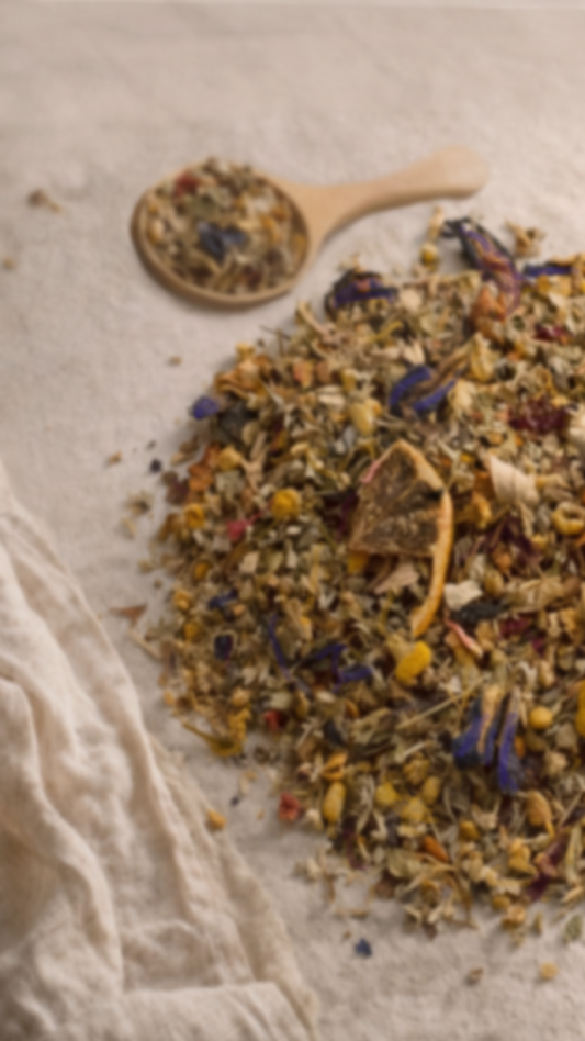 Herbal tea mix with a wooden spoon on a textured linen surface